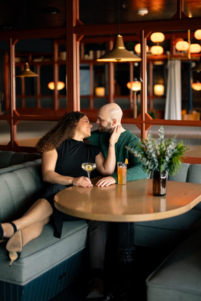 couples snuggling in a cocktail lounge booth