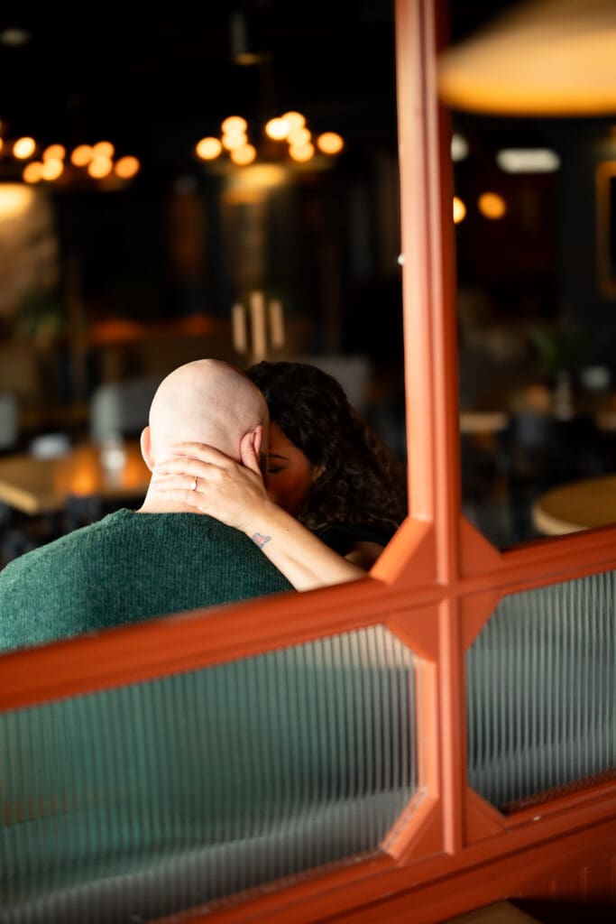 couples snuggling in a cocktail lounge booth