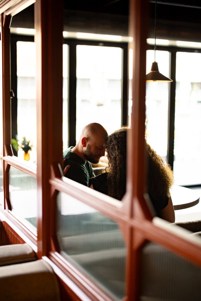 Couples snuggling in a cocktail booth from afar