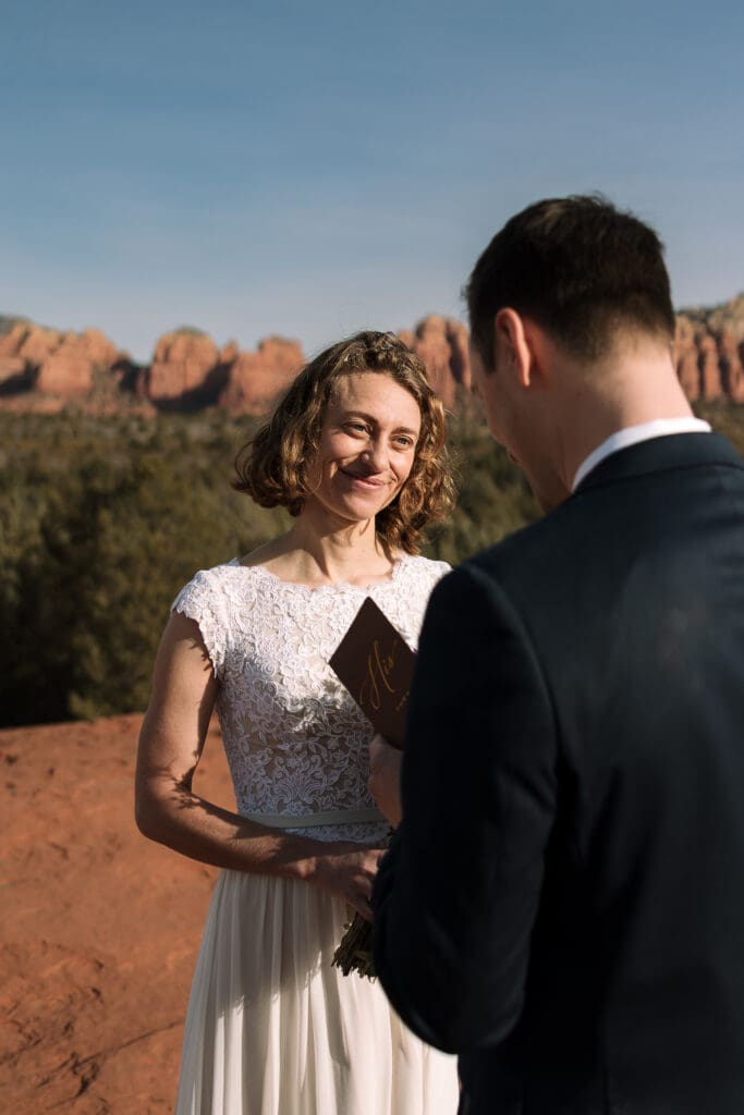 A groom shares intimate vows with his bride.
