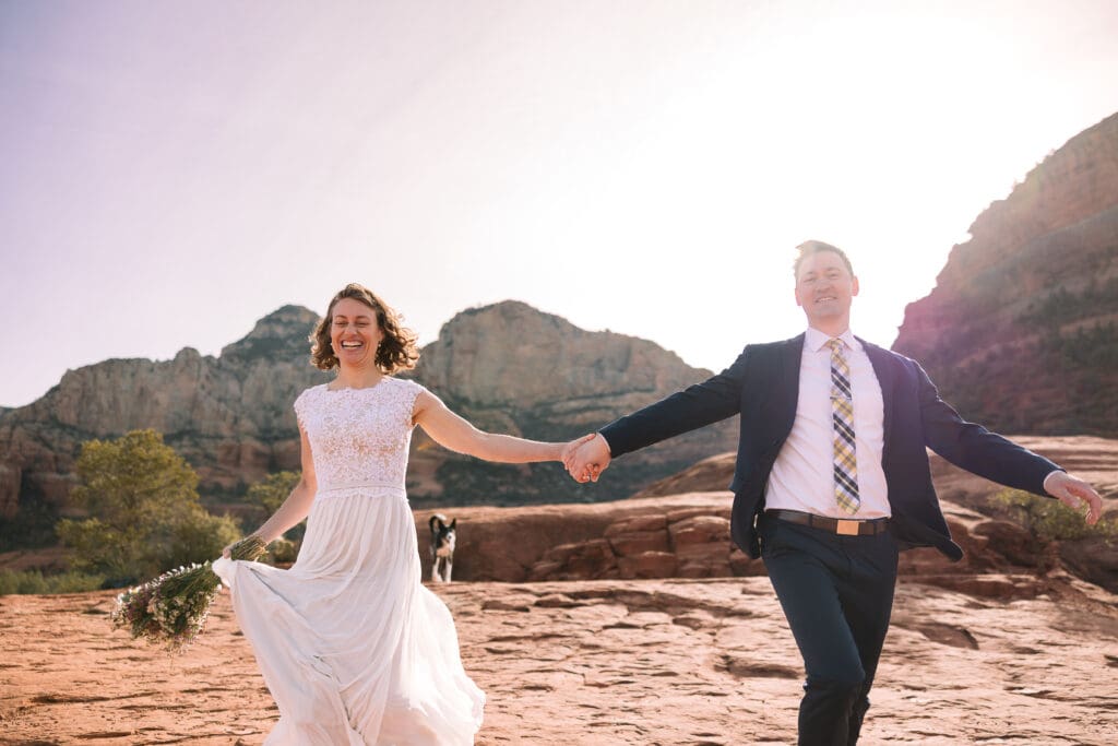 A bride and groom run toward the camera as newly husband and wife.