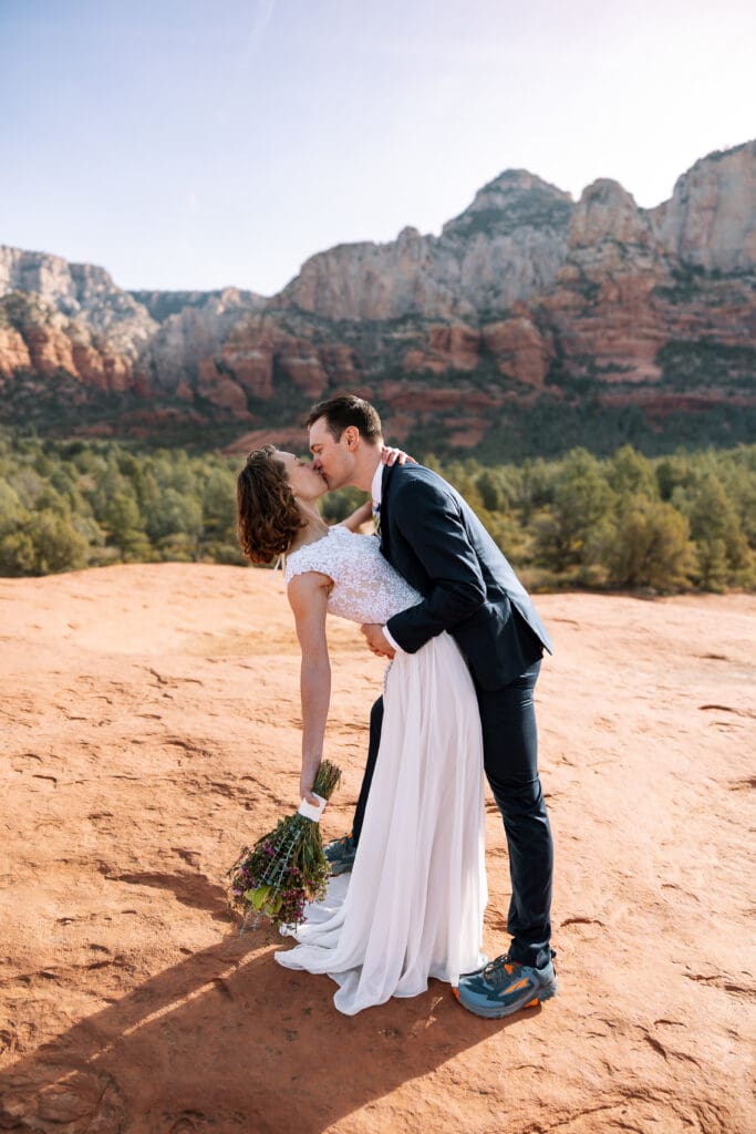 A bride and groom share a first dip after their first kiss.
