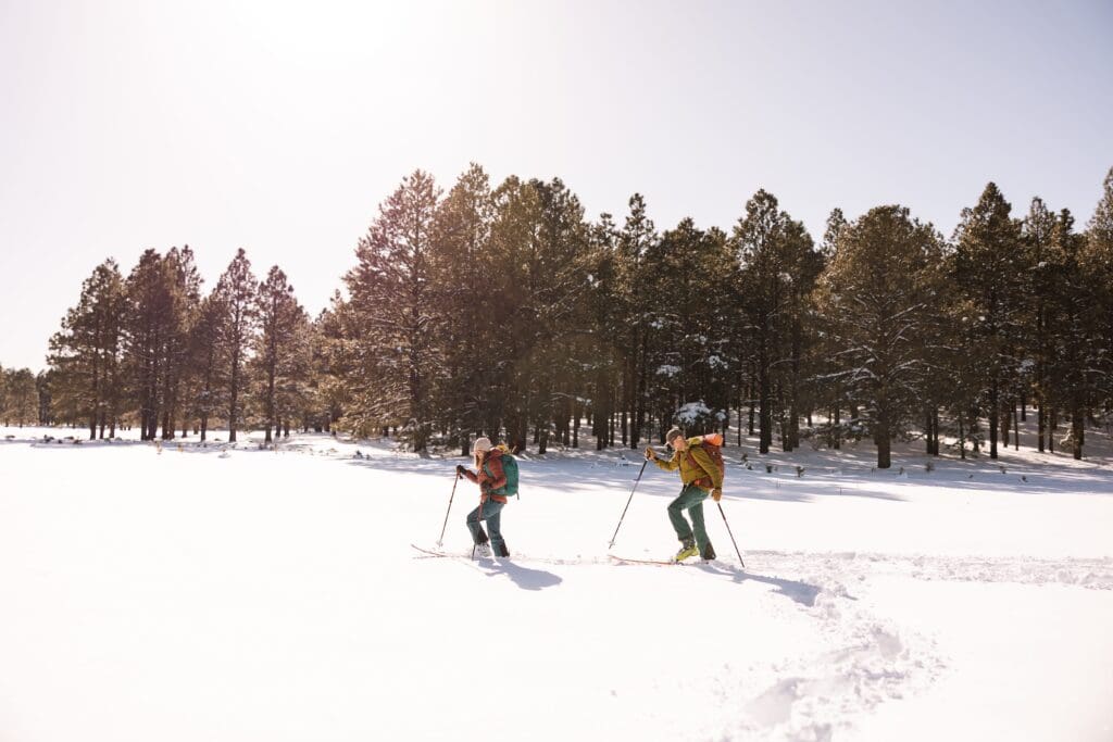 Bride and groom are cross country skiing their way to the ceremony site.