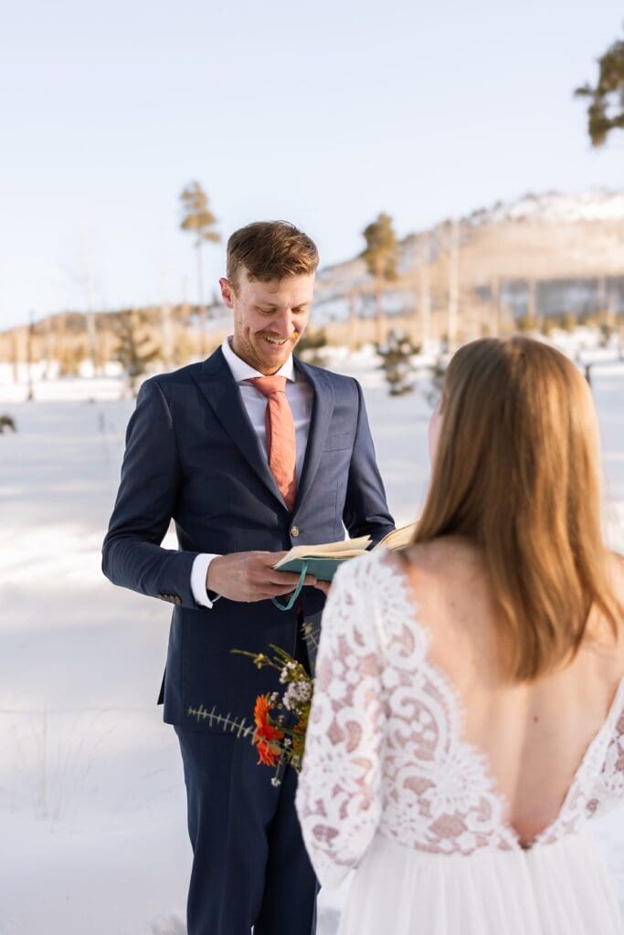 The groom smiles as he exchanges his vow to her. 