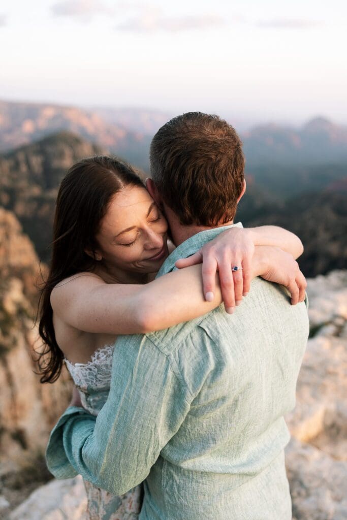 A women hugs her partner with her eyes closed