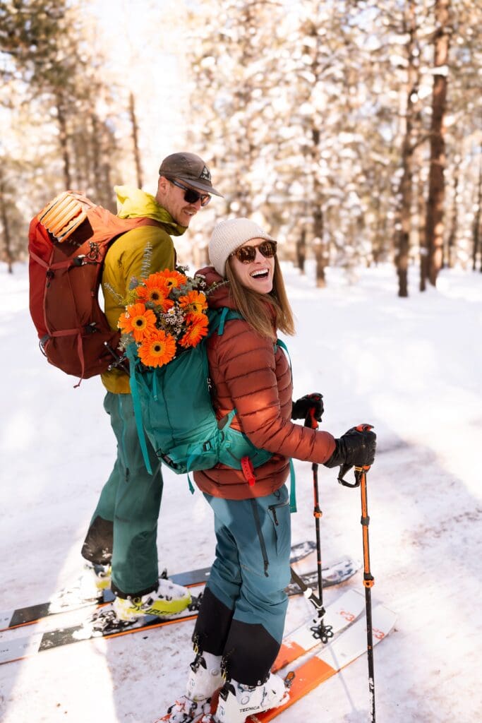 Couple hiking for their adventure elopement with a full packing list in their daypacks.