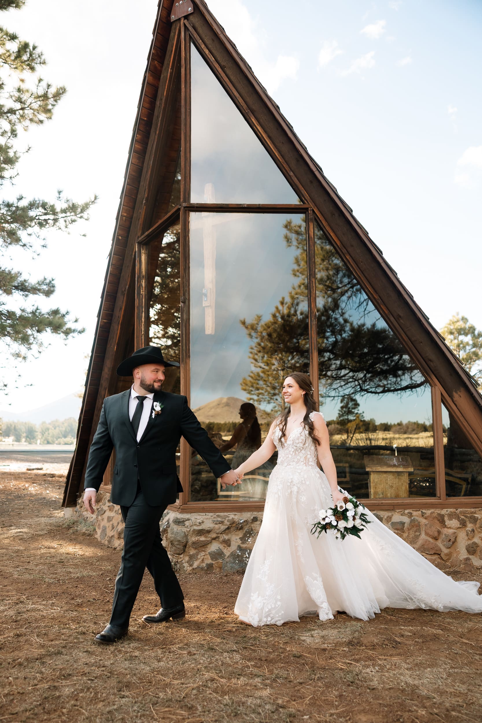 Bride and groom walking out of the Chapel of the Holy Dove during their Flagstaff elopement.