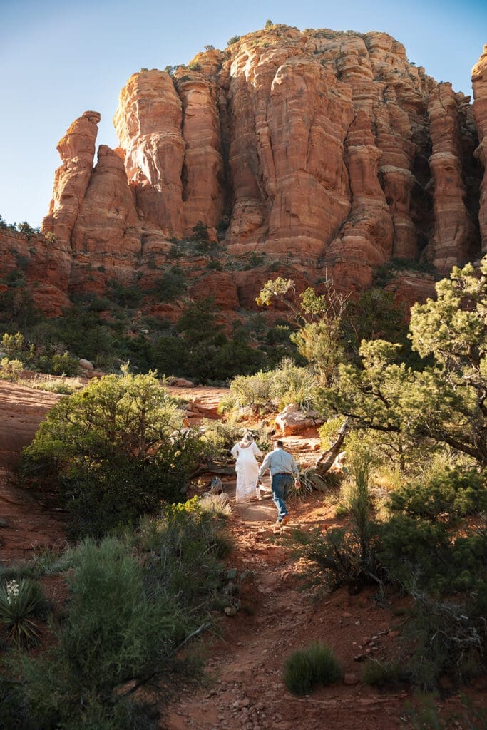 Couple holding hands overlooking red rock canyons in Sedona Arizona near Chicken Point.
