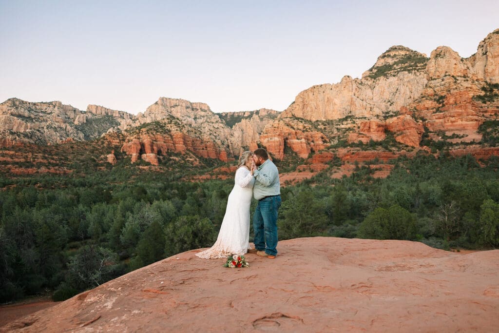 Elopement couple kissing on red rocks at Submarine Rock during a Sedona elopement.