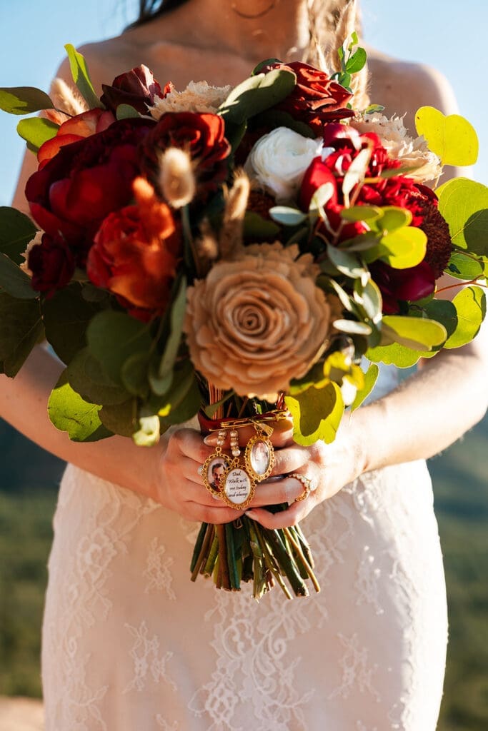 A bride lost her father and had a memory charm made with his photo and chose to clip it to her bouquet.