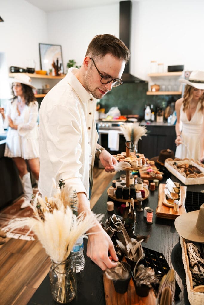 Detailed close-up of custom-branded hats and accessories at a Sage and Stone mobile hat bar for an intimate Sedona elopement.