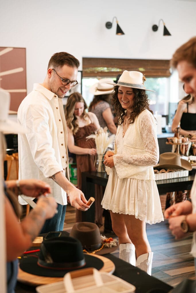 A bride and groom at a Sage and Stone mobile hat bar for an intimate Sedona elopement.